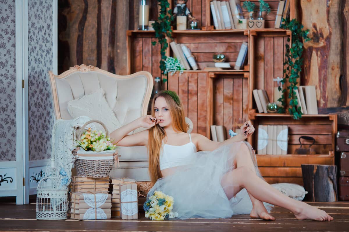young beautiful girl with flower wreath in rustic wood interior library