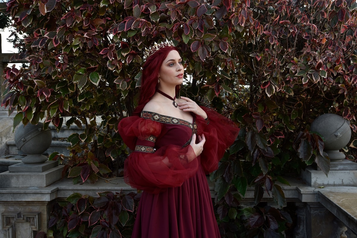 pretty lady with red hair wearing glamorous renaissance red ballgown