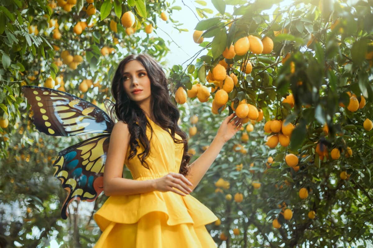 fairy tale girl walking in fabulous lemon garden