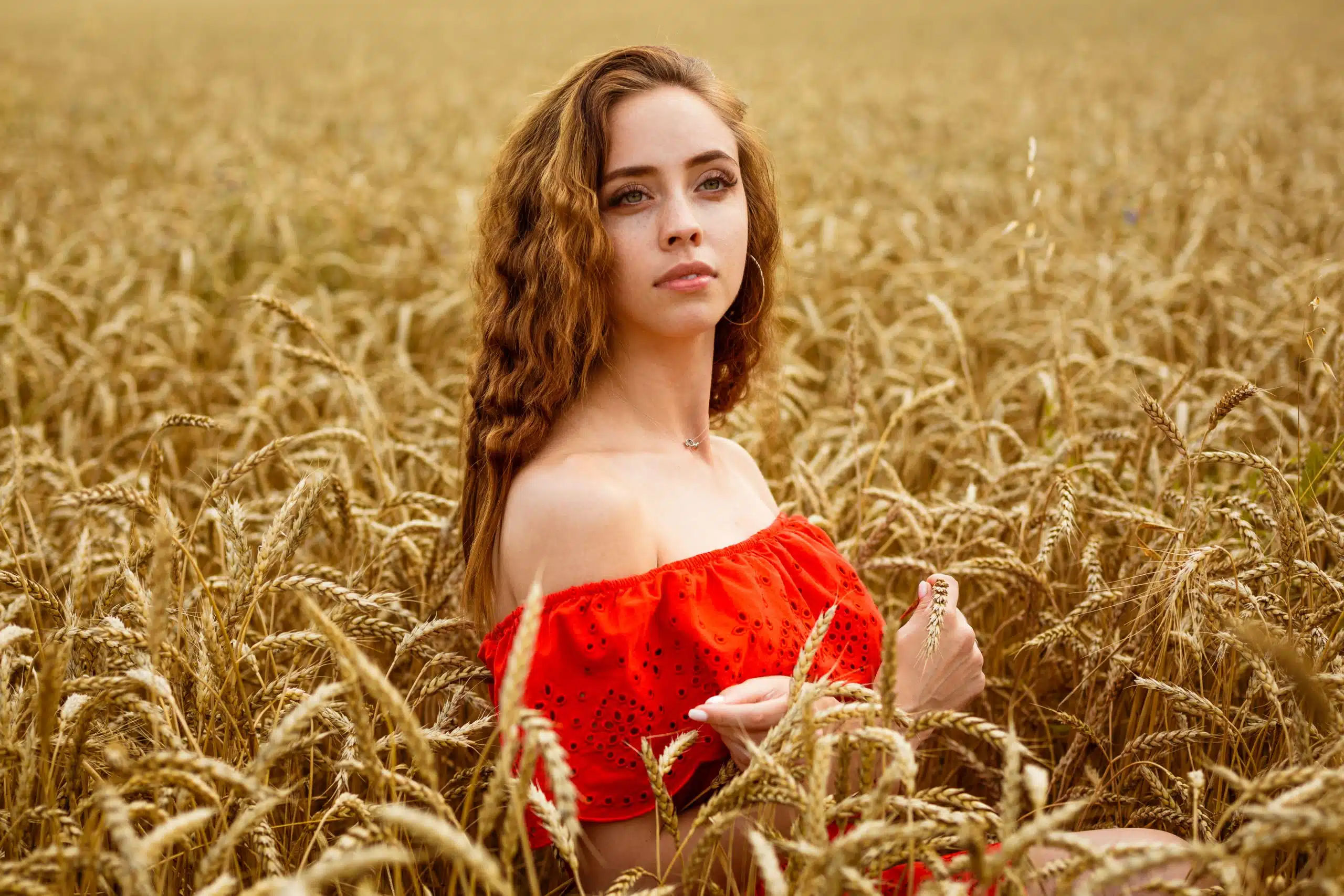 Beautiful woman on yellow wheat field