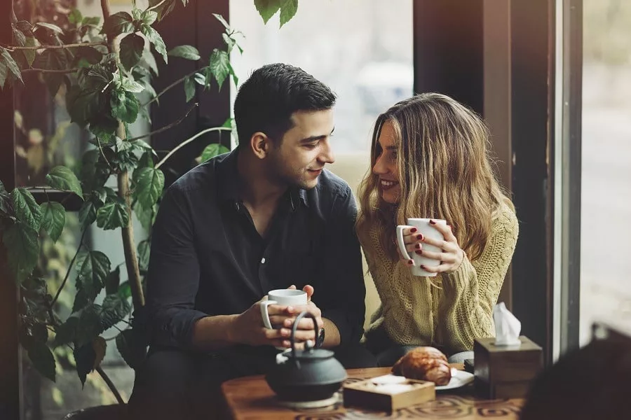 Couple in love drinking coffee in a cozy coffee shop.