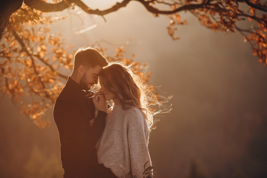 Stylish young couple in love in the autumn mountains.