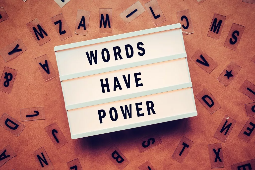 Words Have Power phrase written on white platform.
