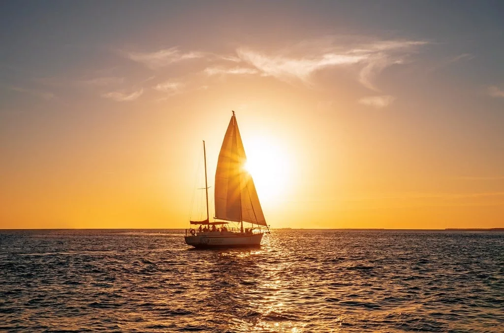 Sailing yacht in the ocean at sunset.