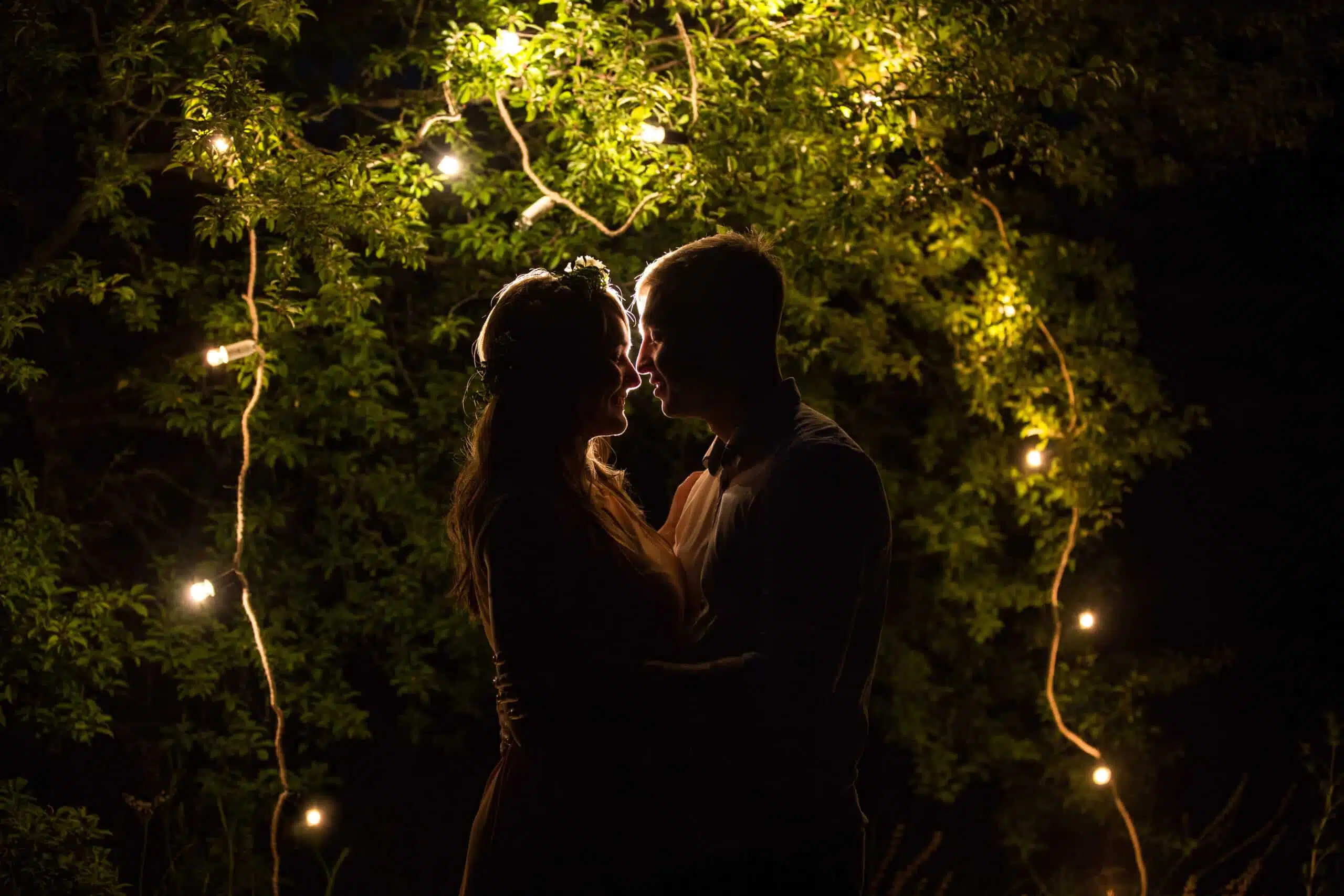 Couple in love, mysterious silhouette of woman and man near ligh