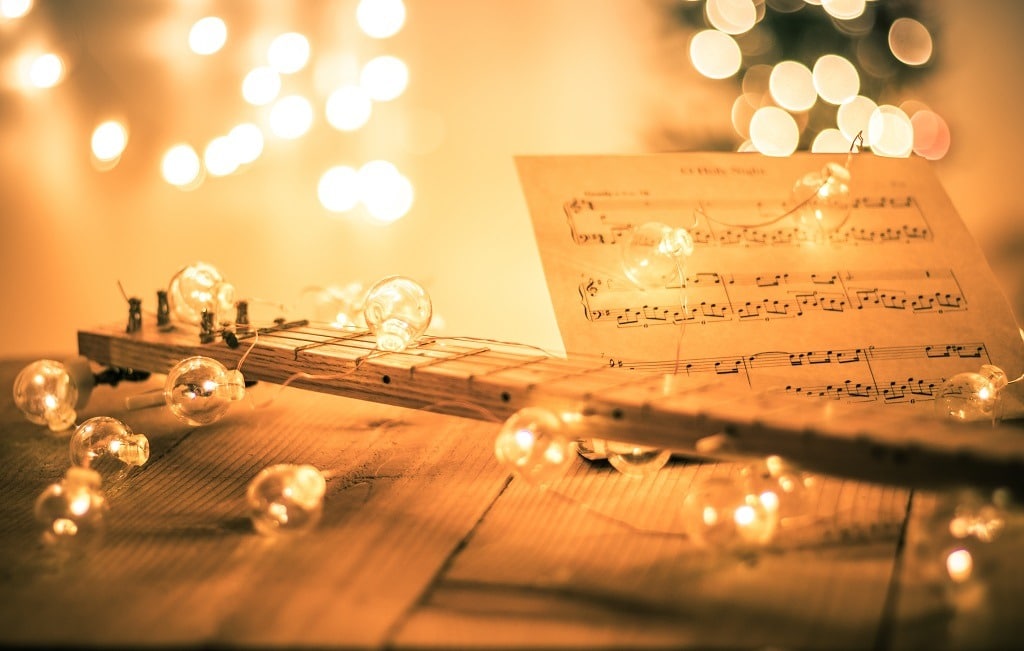 Instrumental sheet music and soft lights for Christmas holiday.