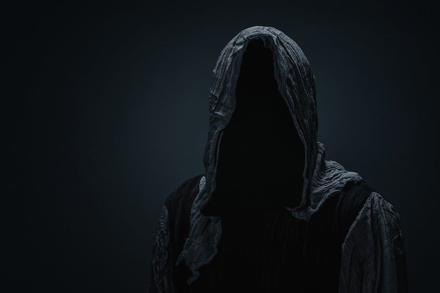 Silhouette of Grim Reaper over dark gray background.