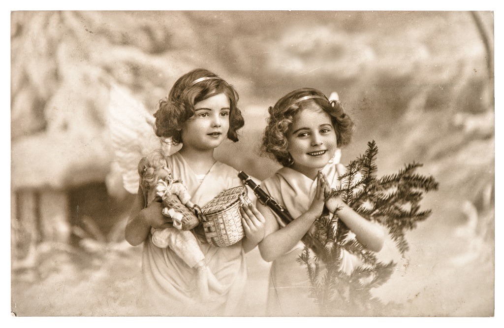Vintage angel girls with white wings, toys and Christmas tree.