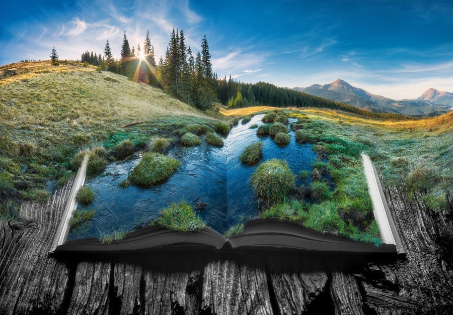 Picturesque life-like view of alpine mountain valley on the pages of an open book.