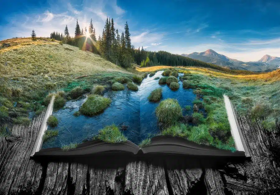 Picturesque life-like view of alpine mountain valley on the pages of an open book.