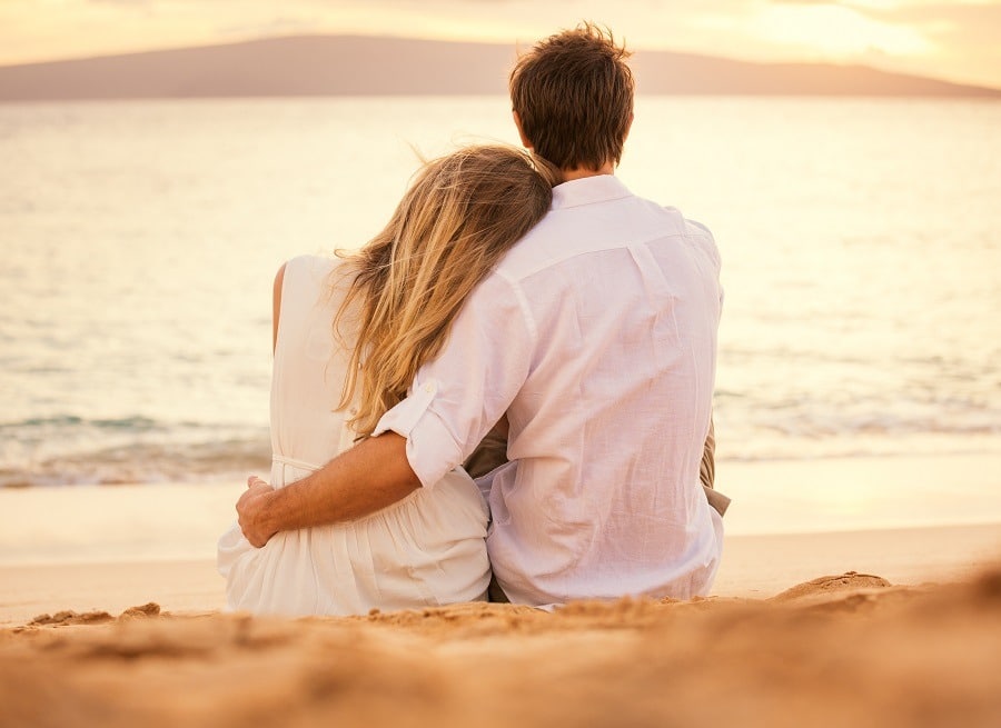 Young couple deeply in love on the beach sunset.