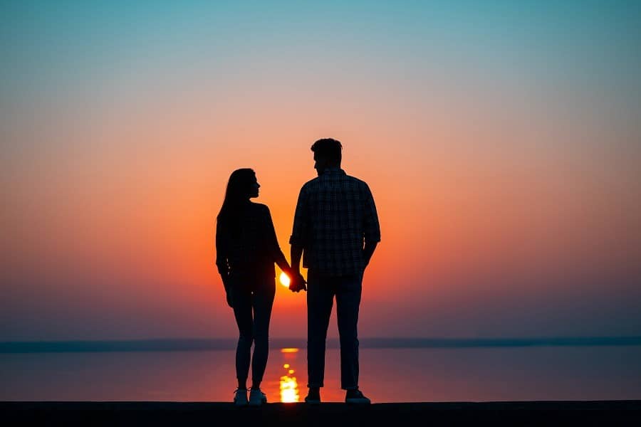 Couple silhouette against the beautiful sunset.