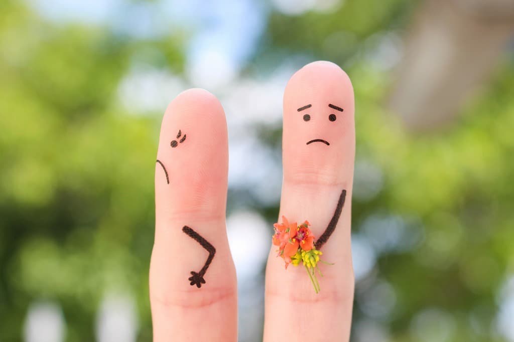 Fingers art of couple, man gives a woman a bouquet of flowers, she is not satisfied.