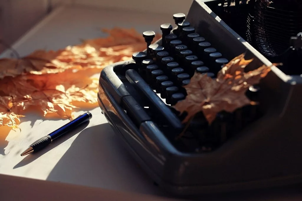 Vintage typewriter with autumn leaves.
