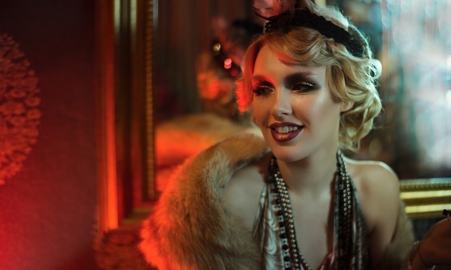 Beautiful sophisticated woman in retro style smiling at a party.