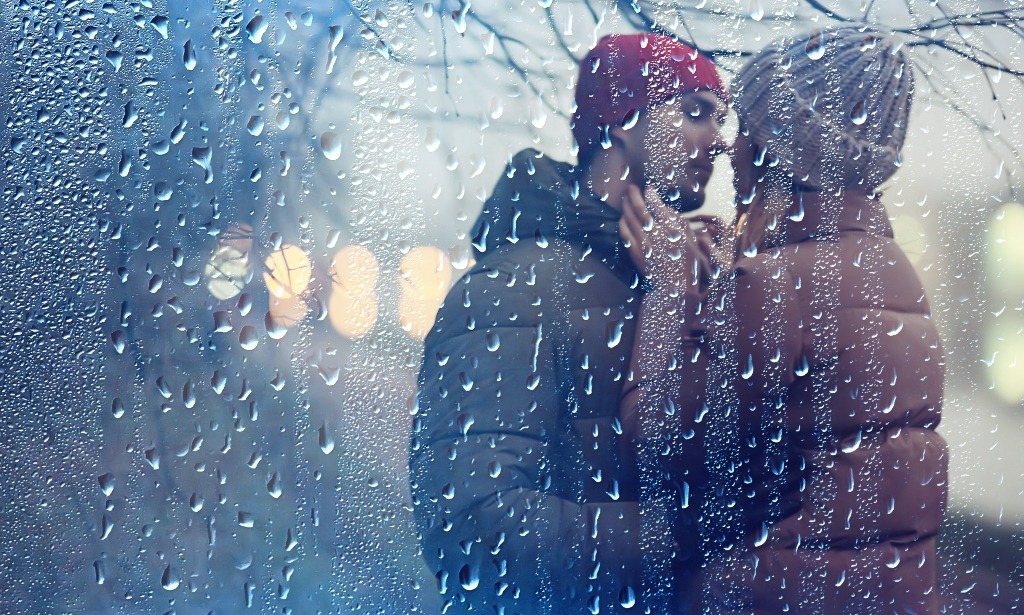Couple hugging outside in winter.