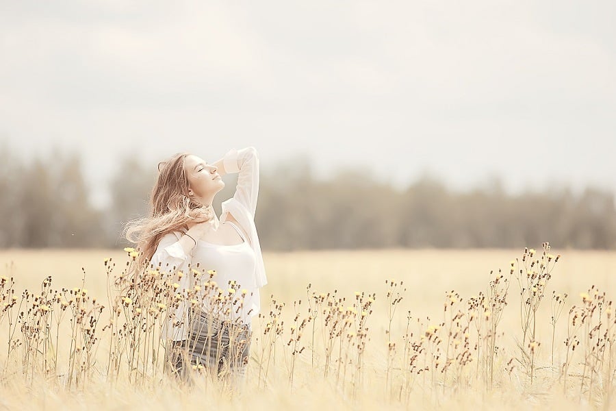 Young woman in the field enjoying the moment outdoor.