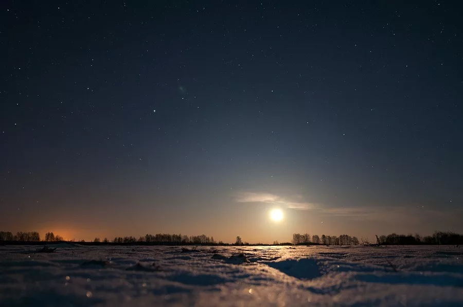 Moon rising over the field, winter night.