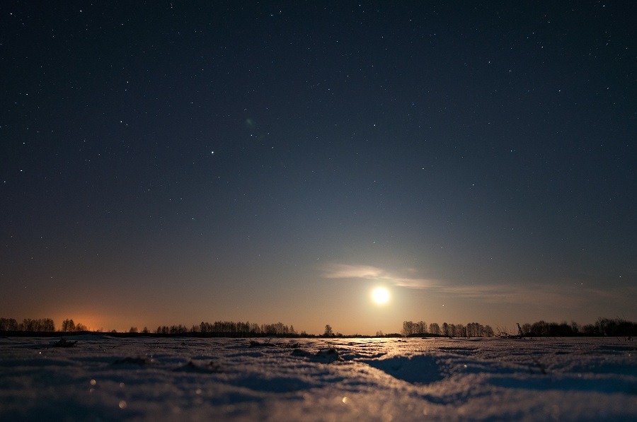  Moon rising over the field, winter night.