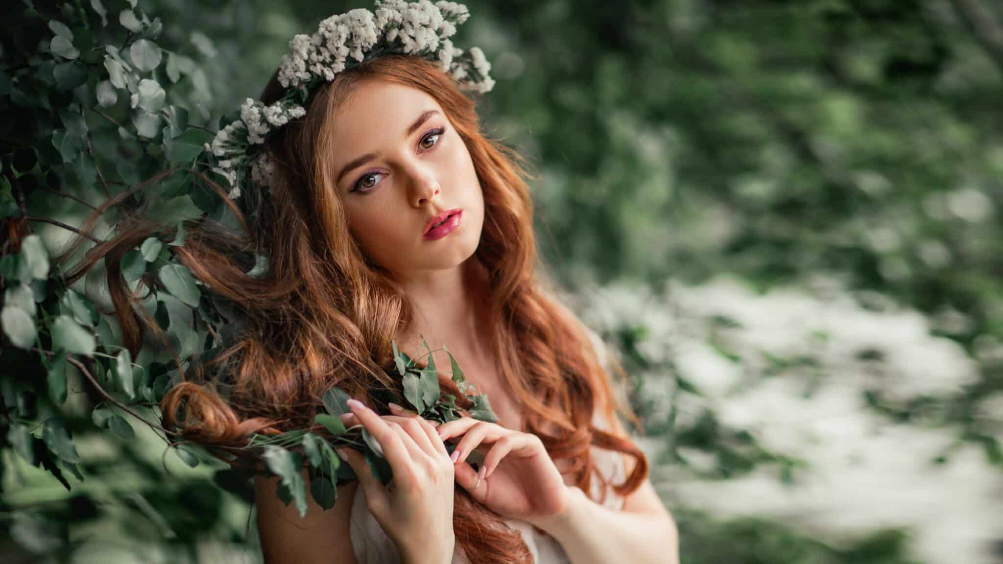 Beautiful red haired girl in white vintage dress and wreath of f
