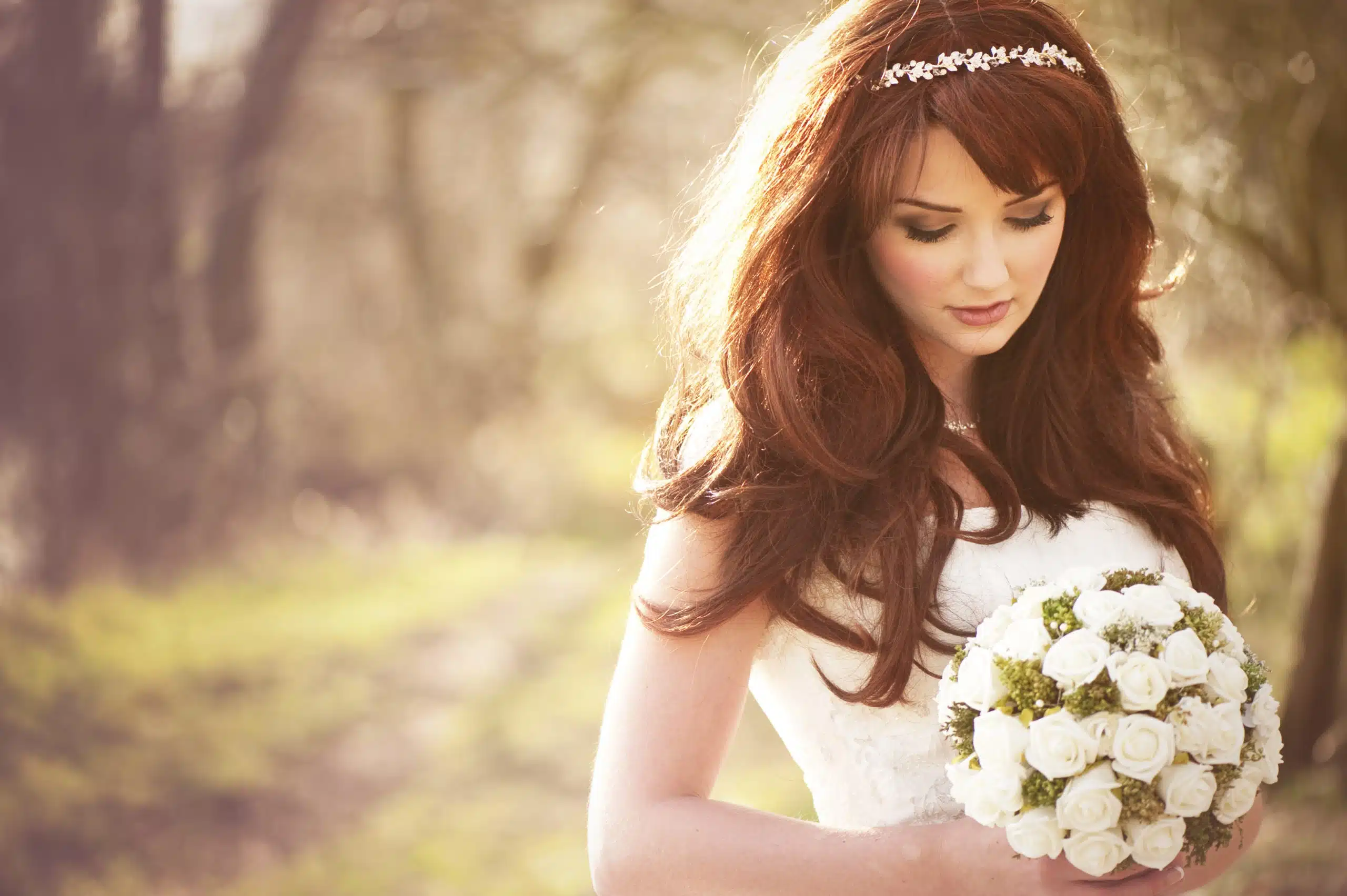 Beautiful bride with a bouquet of white roses