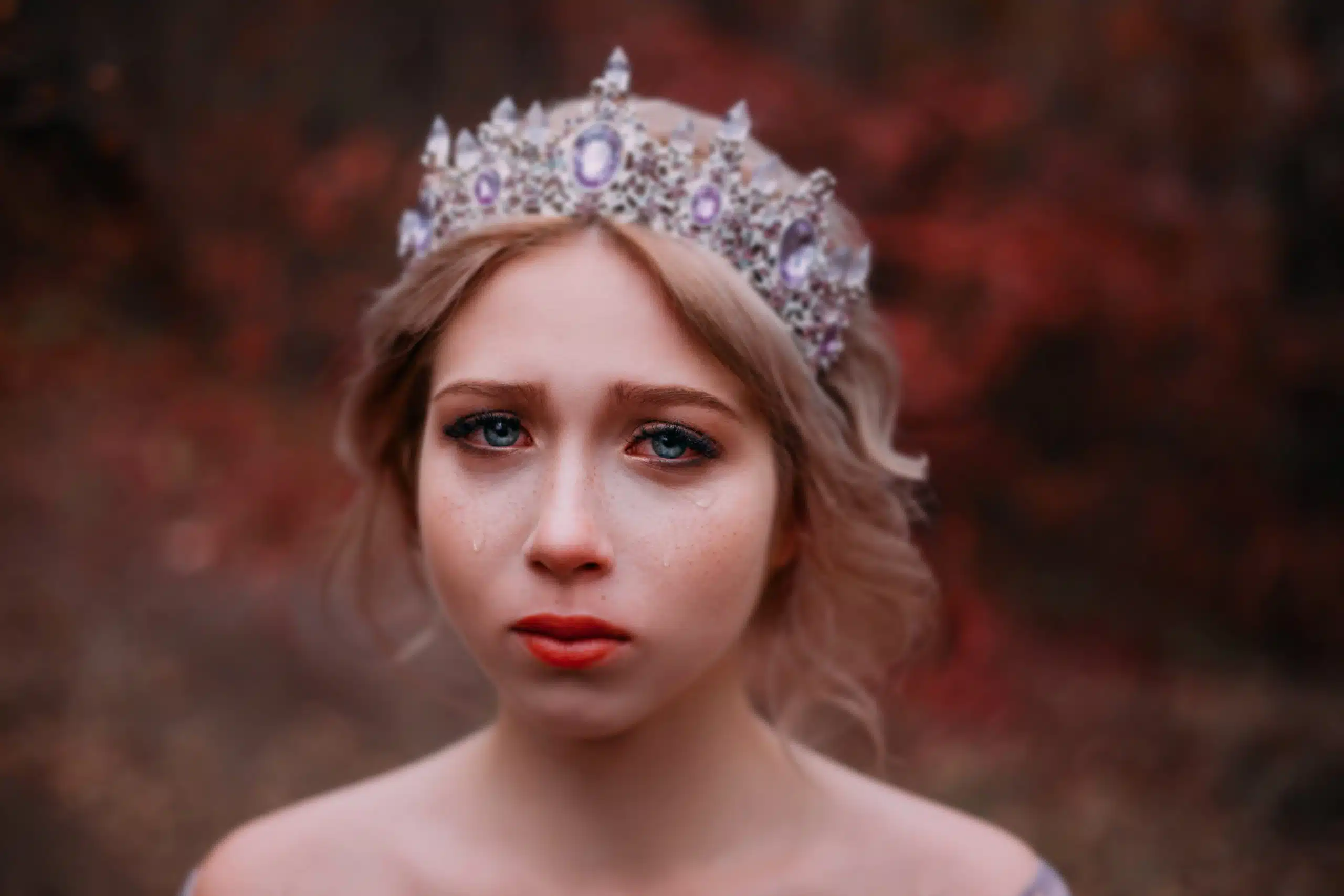Sad beautiful woman with blue and teary eyes
