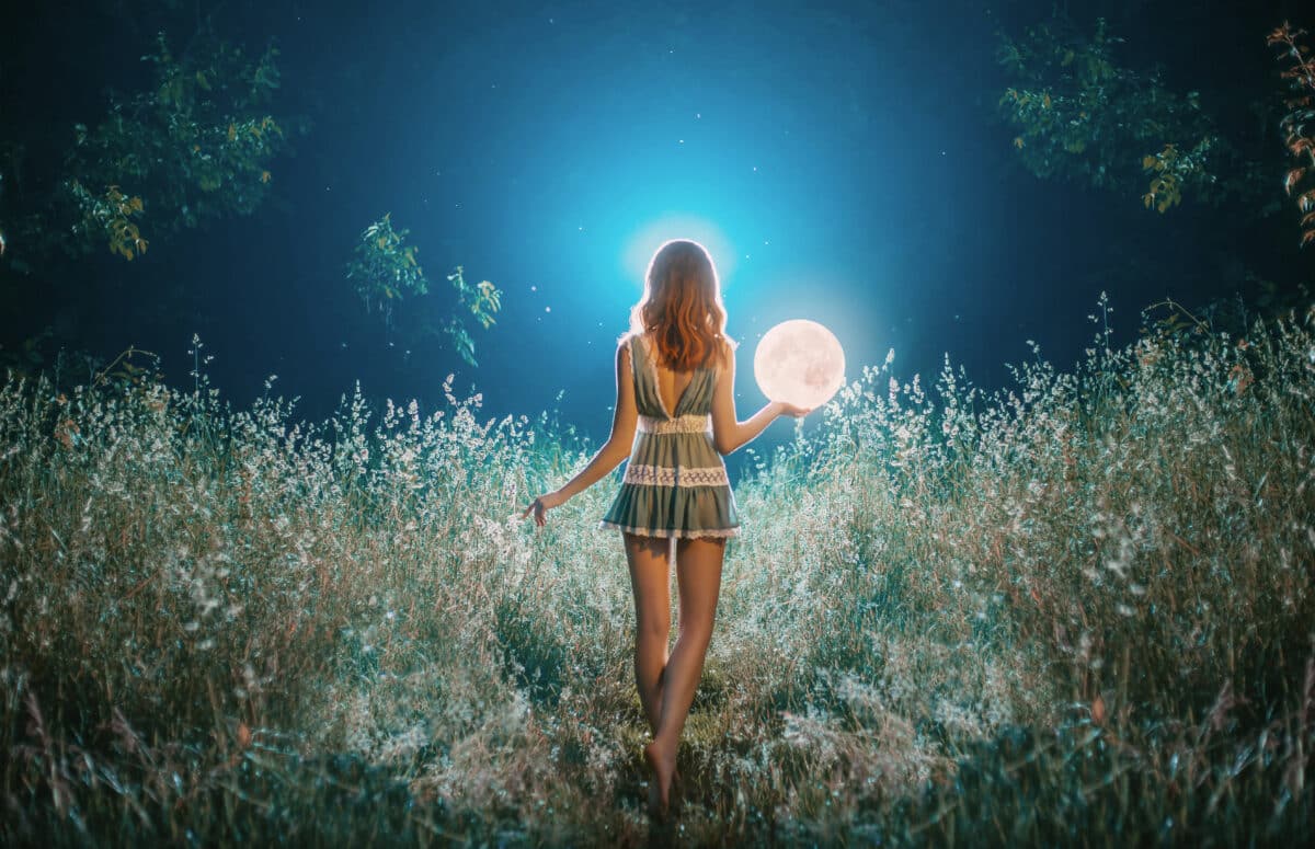 Fantasy silhouette girl holds magical ball planet galaxy. night nature dark forest. Mystic moon light magic universe space in hands of woman. Fairy bright sparkle stars white fog blue. Back rear view.
