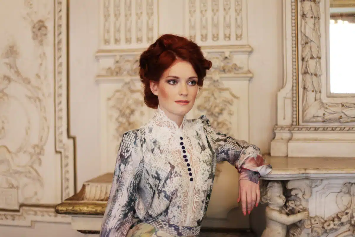 a beautiful noble woman standing in the palace room.