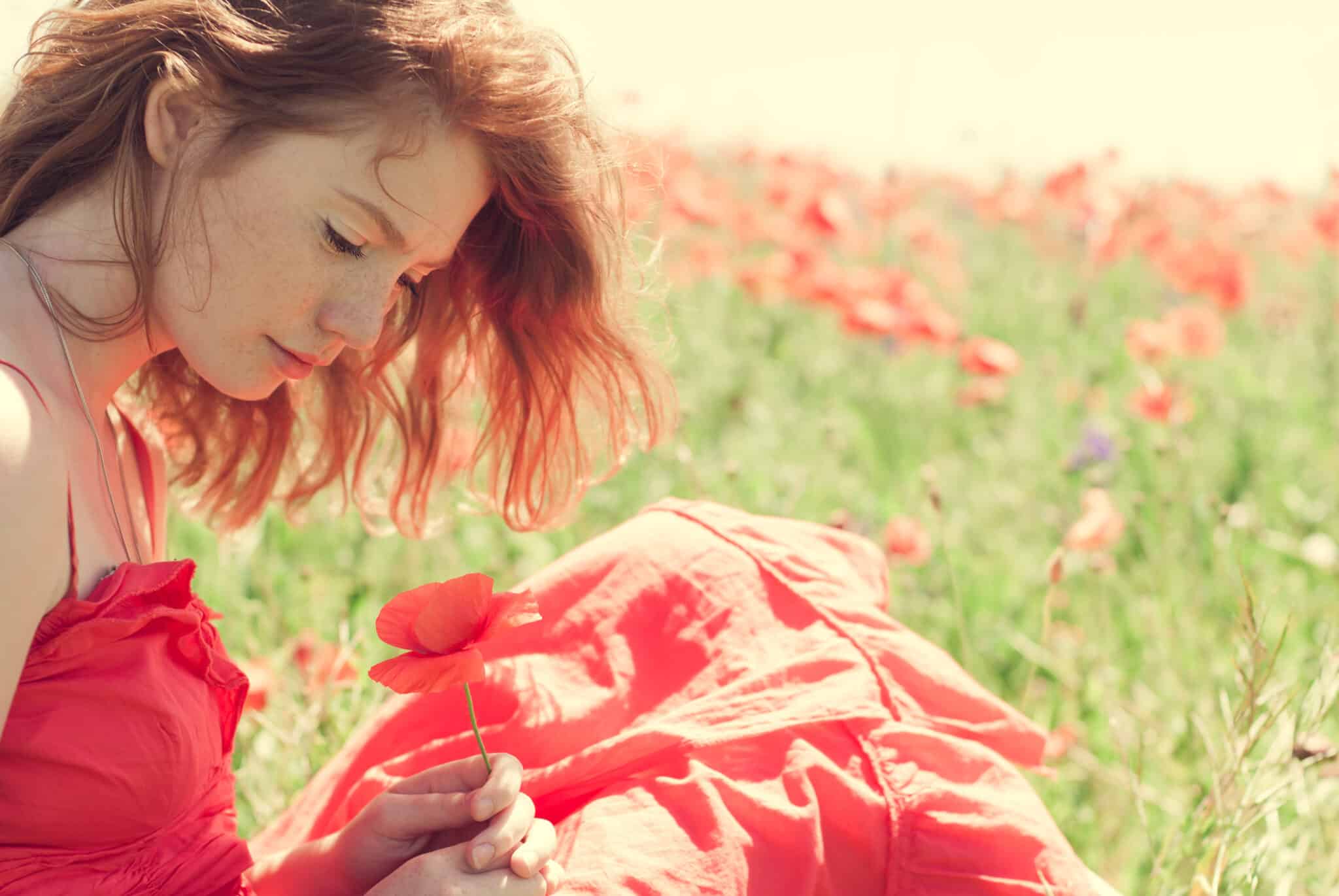 red-haired girl in a wonderful summer field