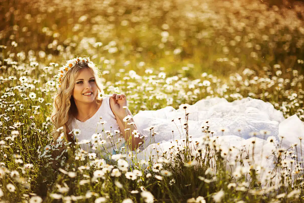 a beautiful blonde in a chamomile field