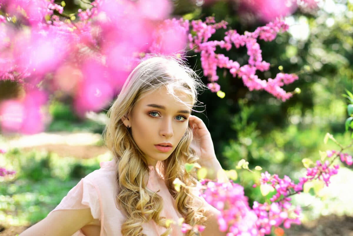 a young woman enjoy flowers in garden on a spring day