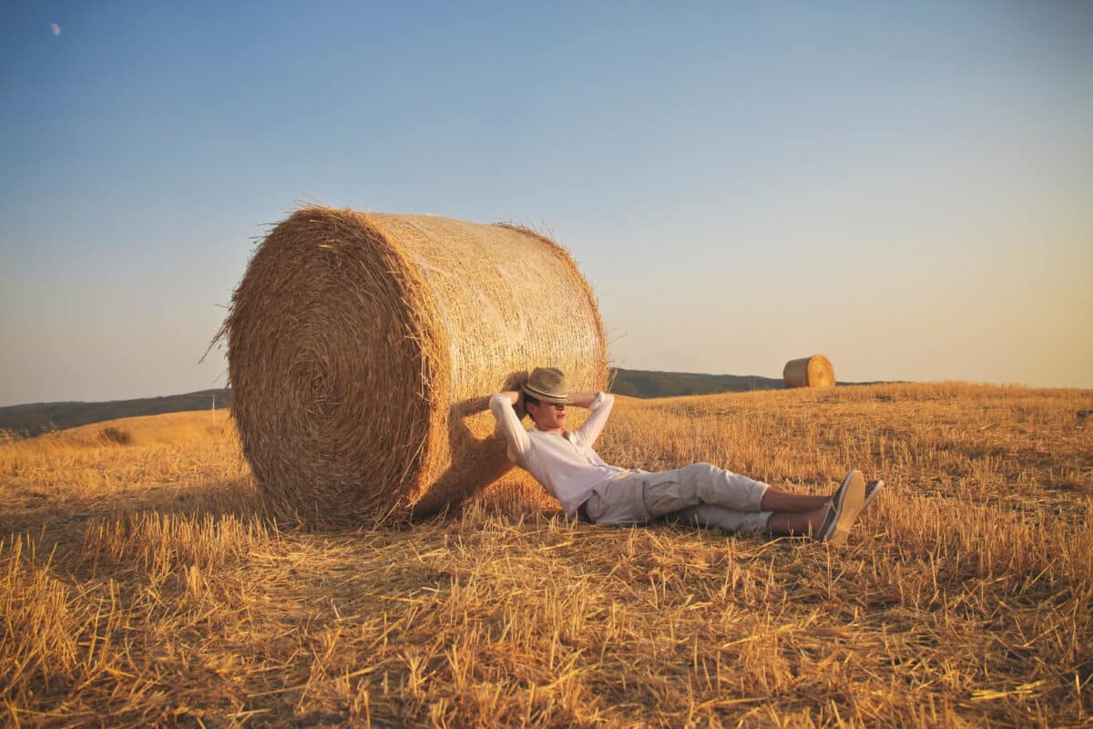 boy resting and leaning in the haycock in the country