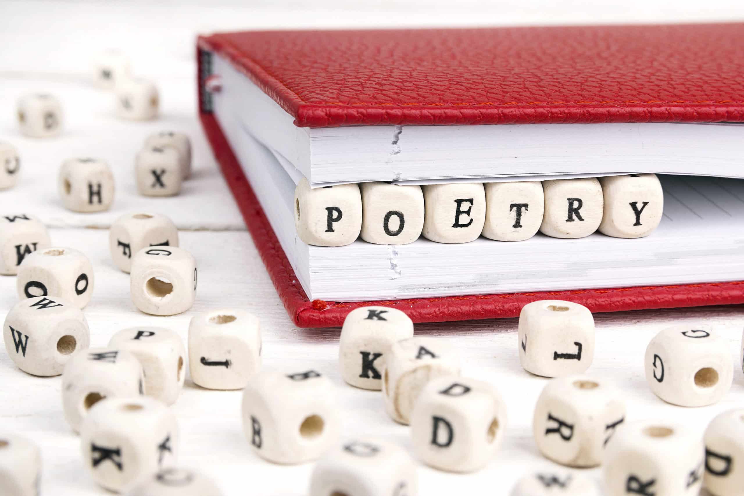 Word Poetry written in wooden blocks inserted in red notebook