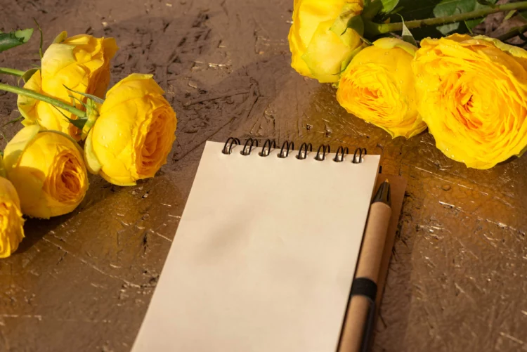 Beautiful yellow summer plants and empty notepad