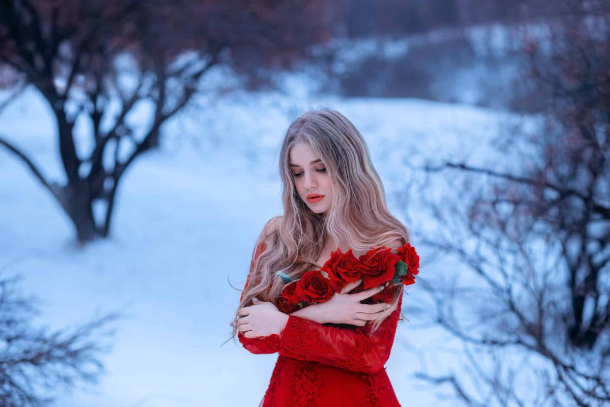 magical image of attractive blonde girl in gorgeous red dress decorated with flowers, 