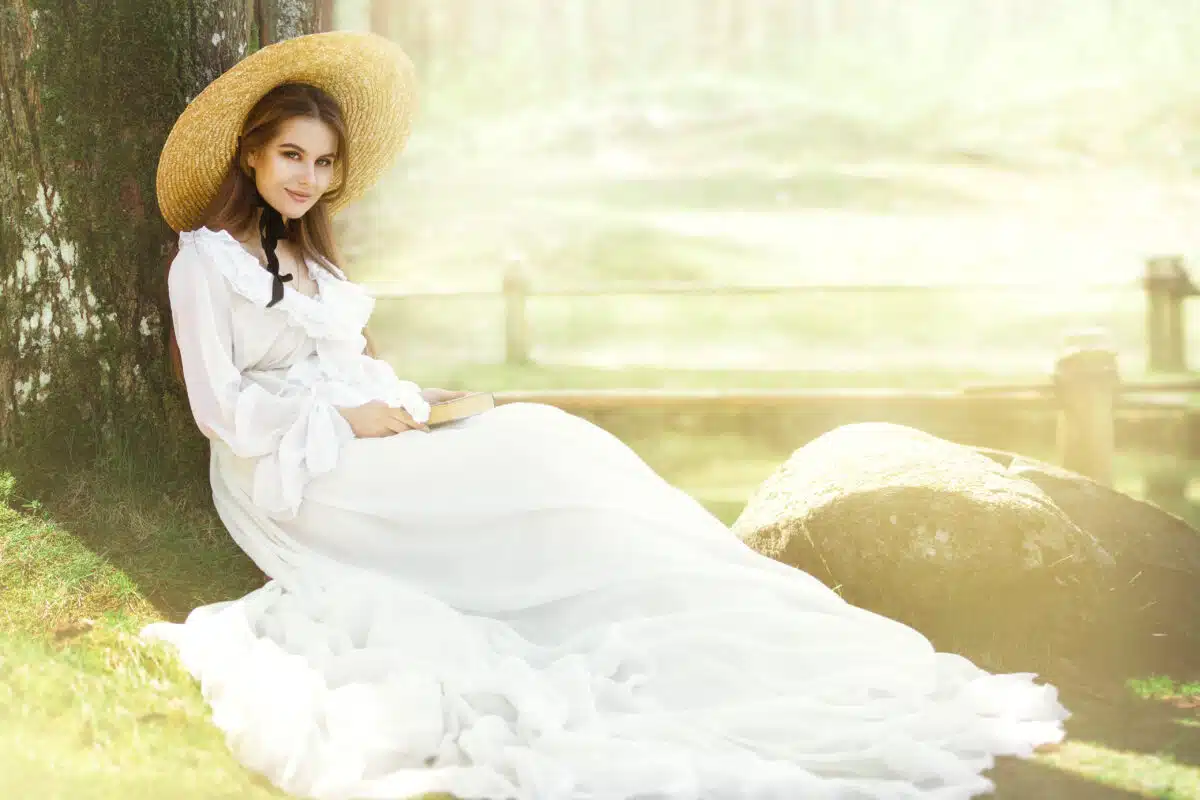 Romantic Woman Victorian Retro Style, Fashion Model in White Dress Wide Brim Hat Reading Book, Outdoor Beauty Portrait