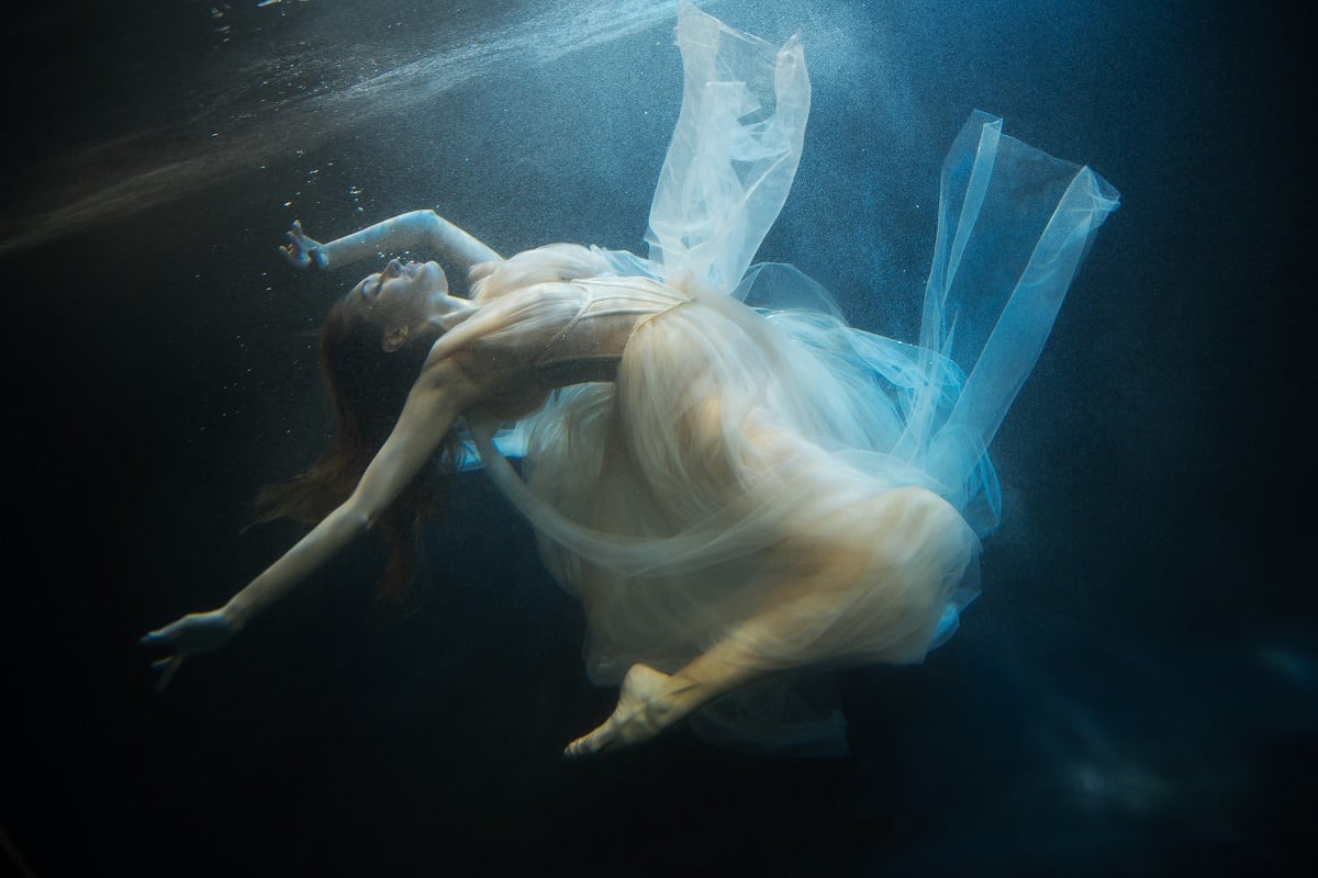 nymph in lace dress underwater