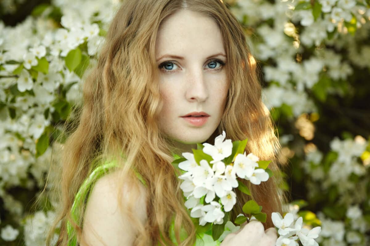  a beautiful young woman in summer garden