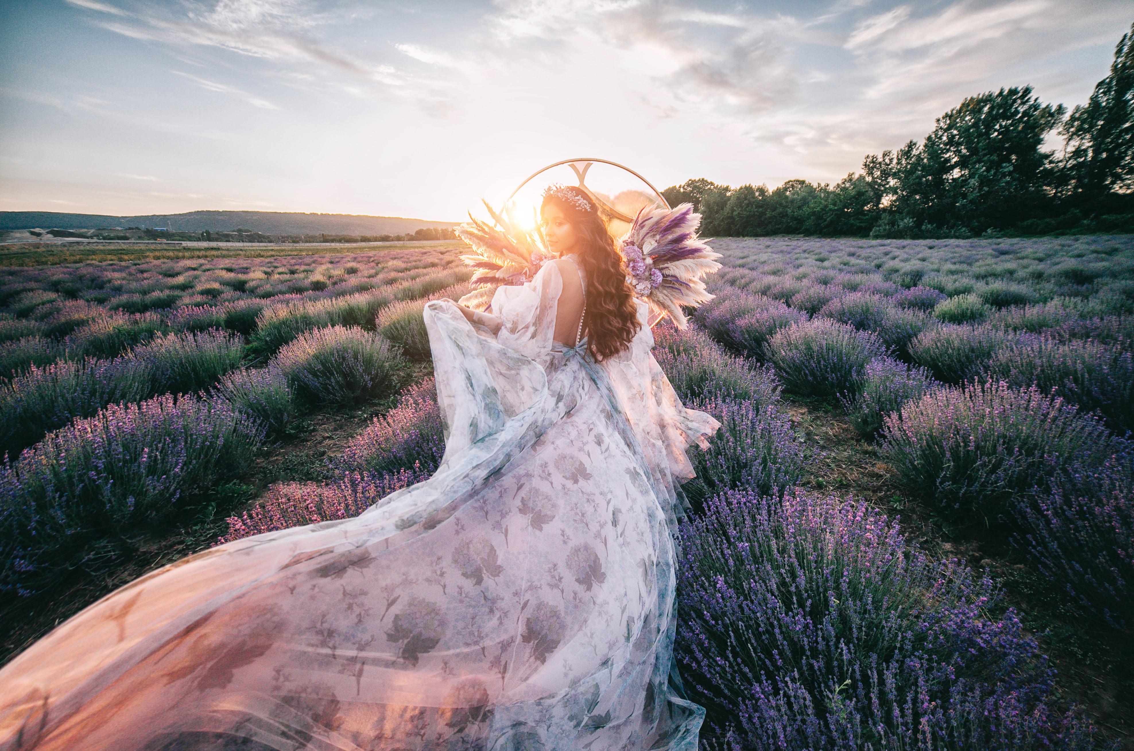 Beautiful bride in a lavender field at sunset. The concept of a