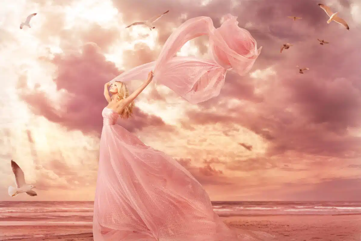 fantasy woman dressed in peach with flying shawl in storm wind