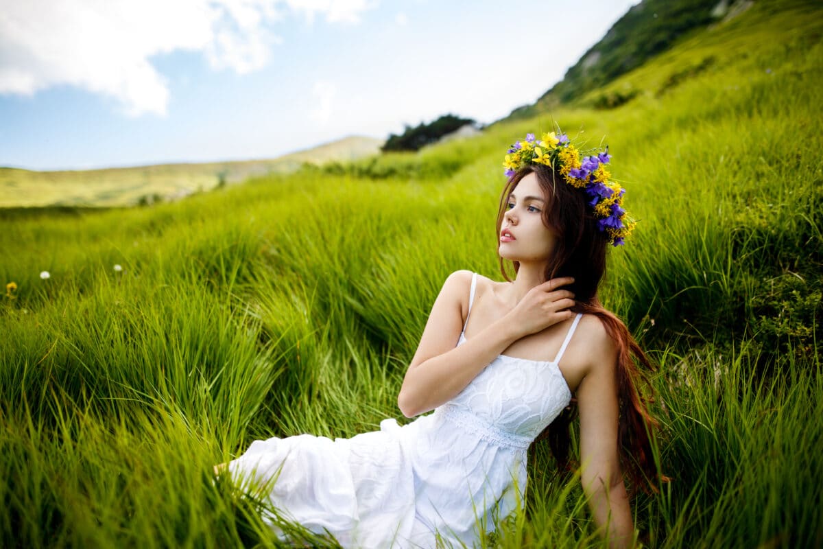 Beautiful woman in a long white dress in the mountains. Young wo
