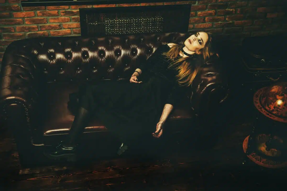 gothic dark woman lying on the sofa asleep