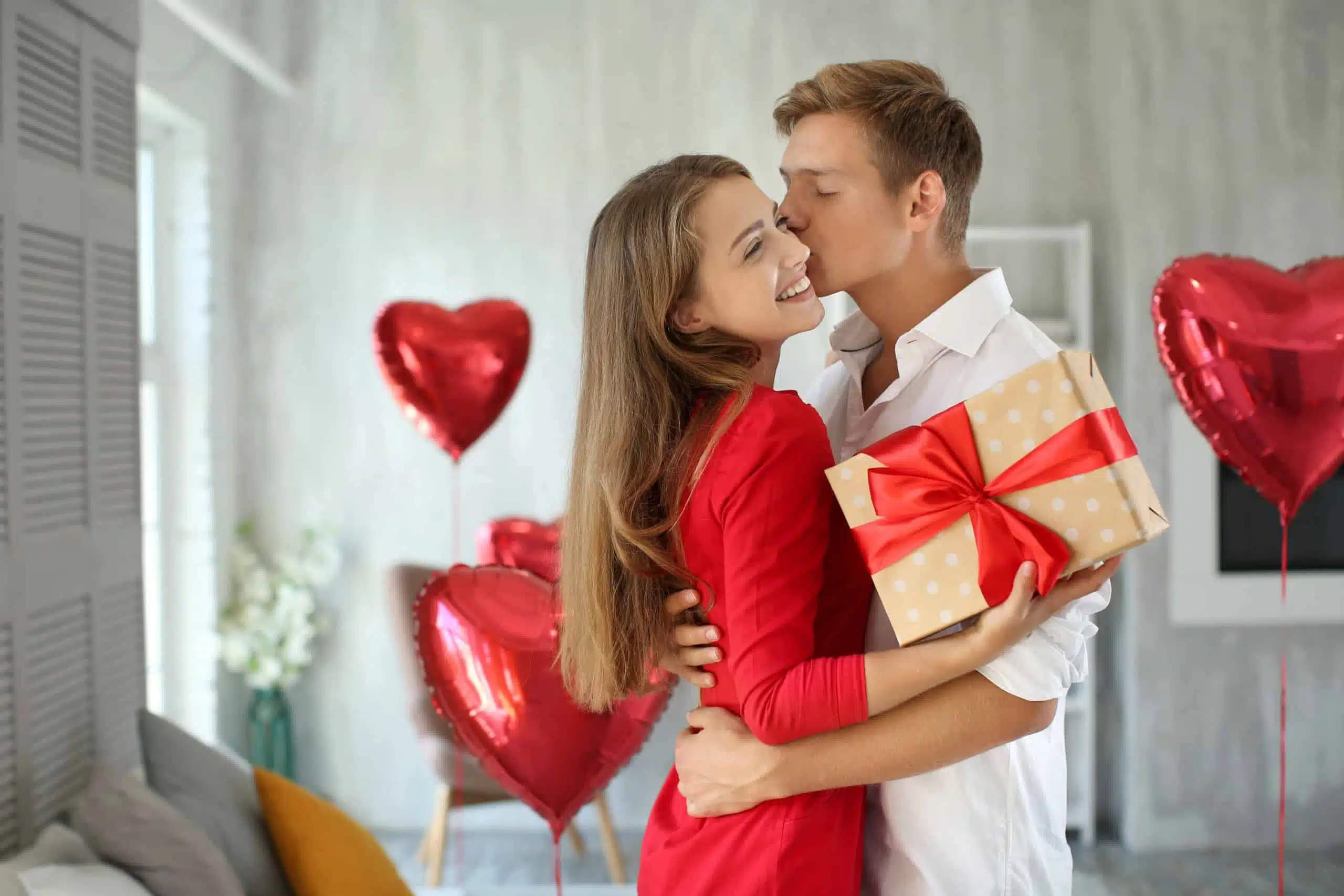 Couple hugging with gift box.