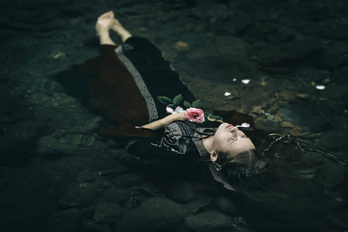 Beautiful floating dead woman in water