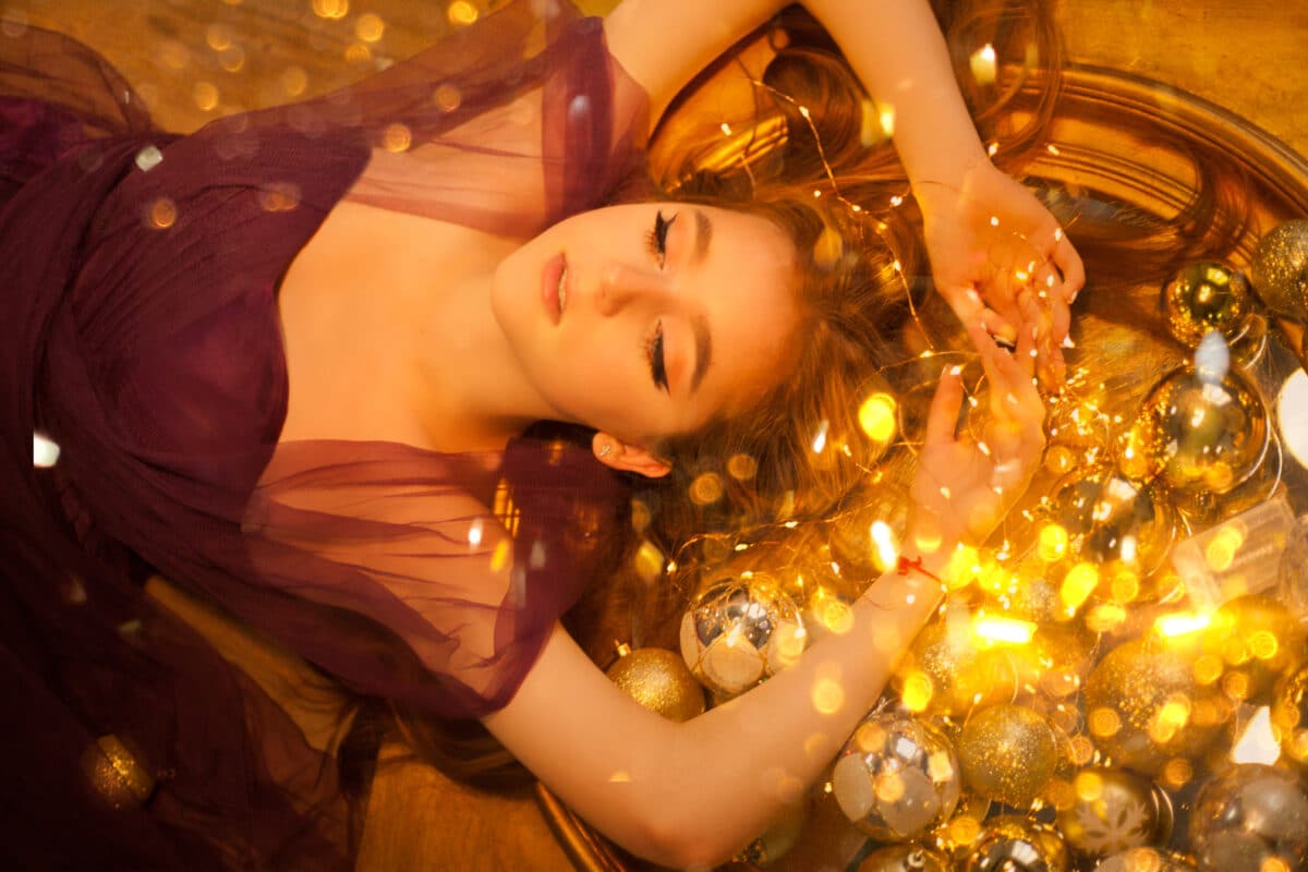 beautiful lady lying on the floor with golden lights