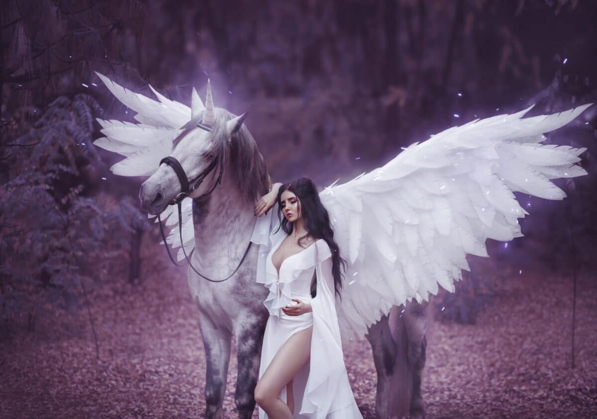 Beautiful, young elf, walking with a unicorn. She is wearing an incredible light, white dress. Art hotography