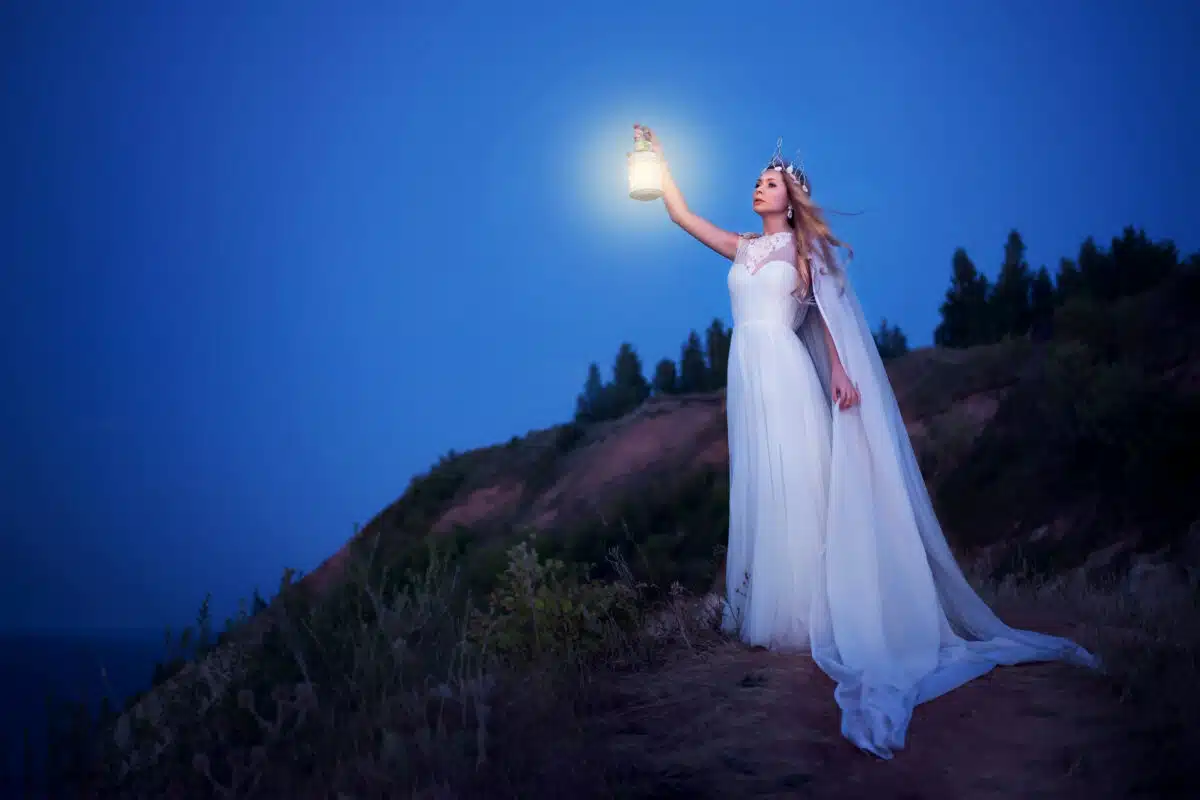 fairy holding lantern lighting way at night