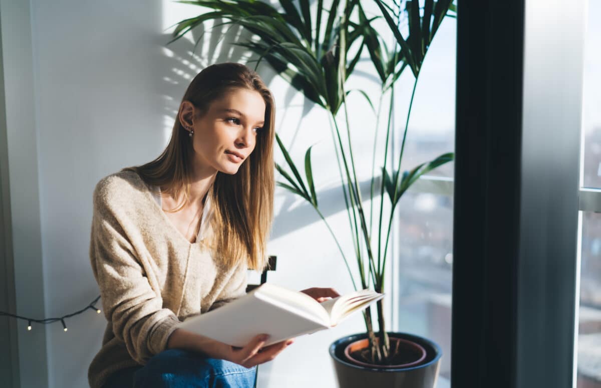 Thoughtful woman with planner working