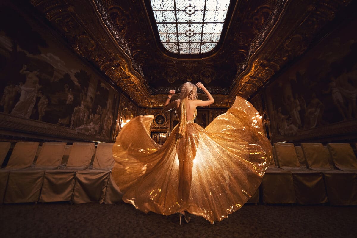 A blonde lady in a luxury gold dress 