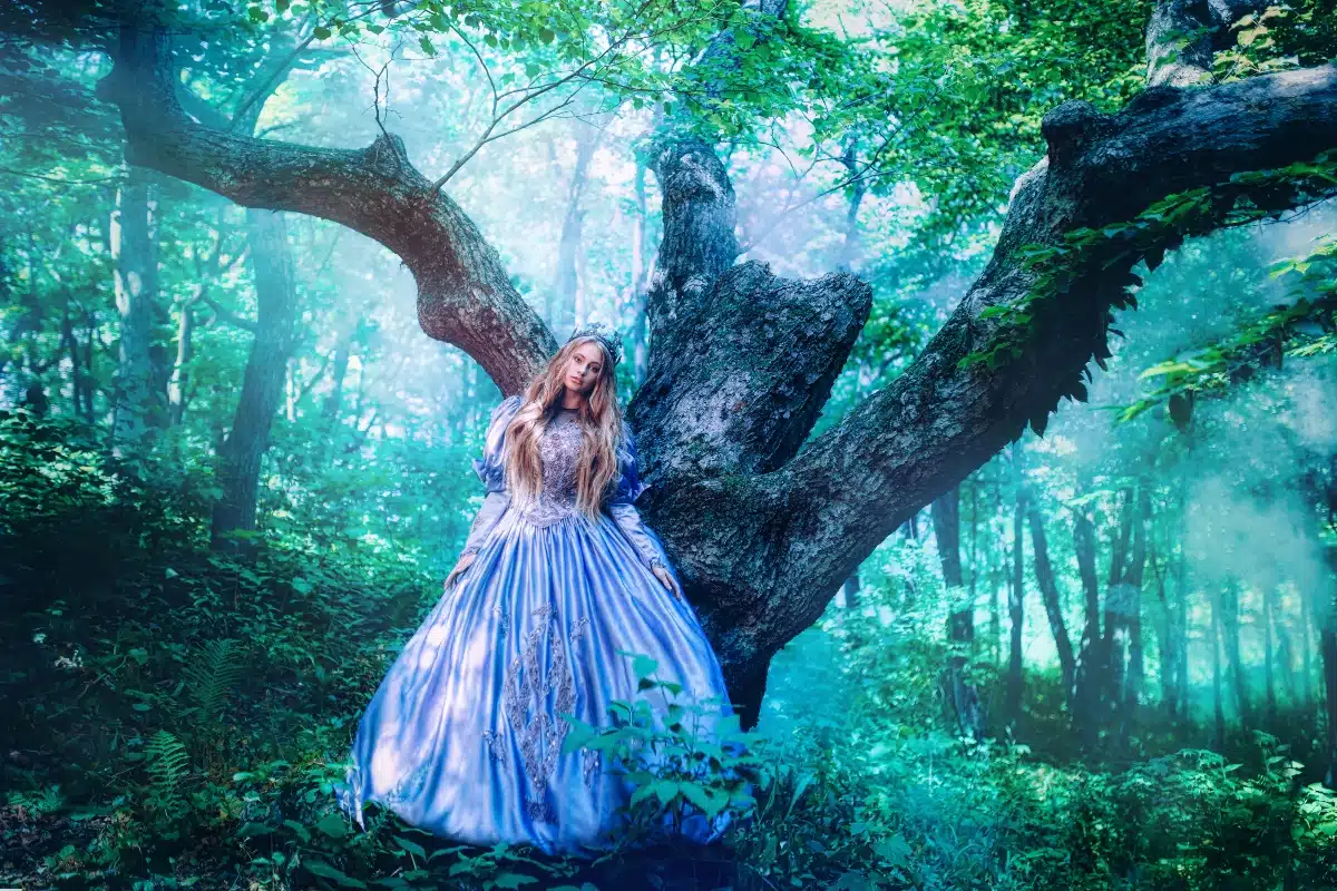 Princess in vintage dress walking in magic forest